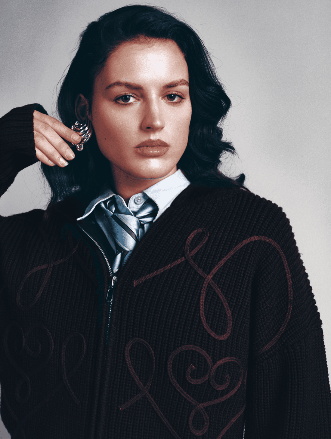 Custom Lou Menais wordmark applied on a contemporary couture garment, showcasing the visual identity developed for the fashion house.
